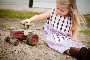 Little Girl Playing with Tractor